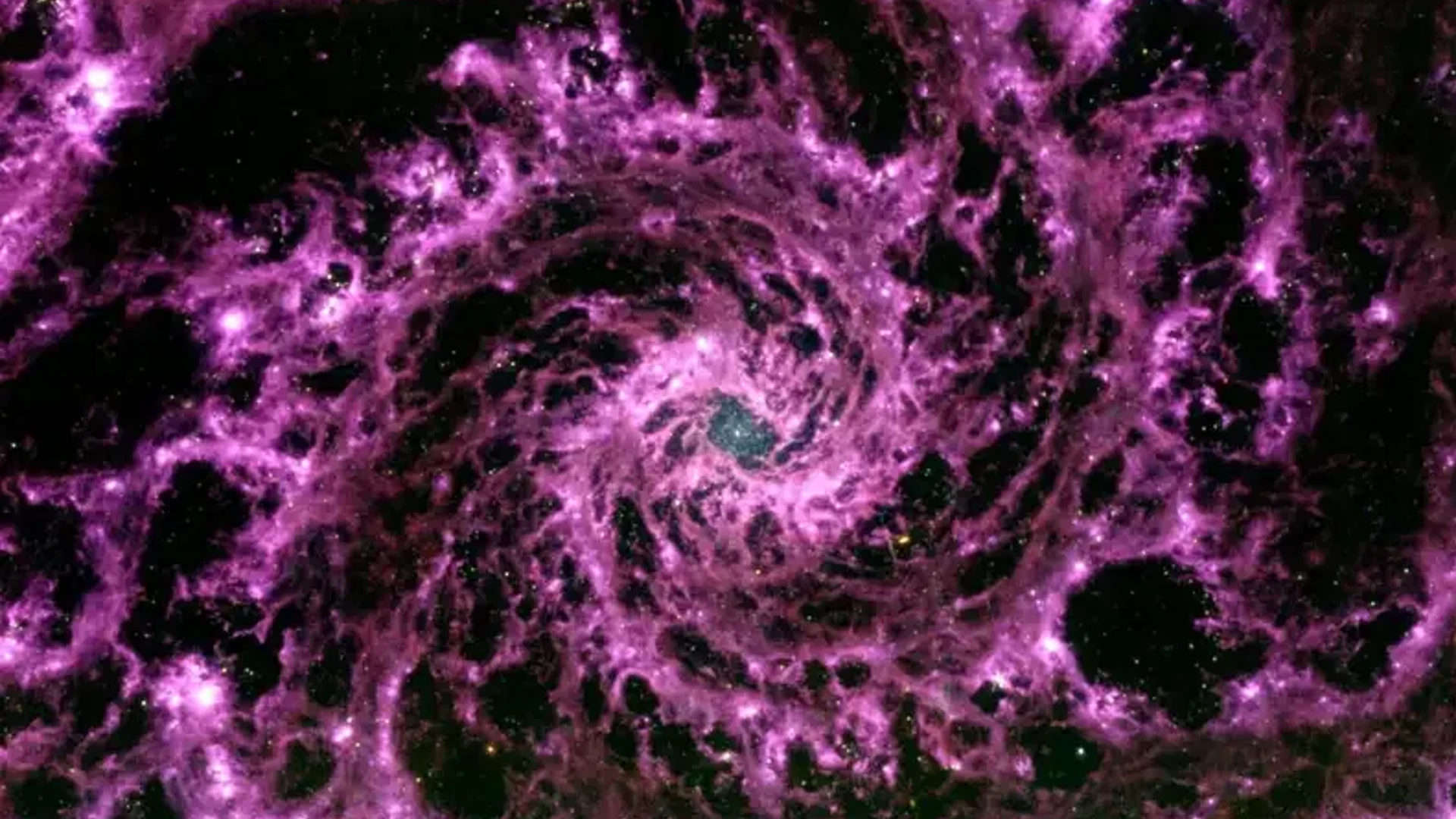 An Amazing JWST Image Depicts A “Purple Cosmic Swirl” Made Of Particles In A Distant Galaxy